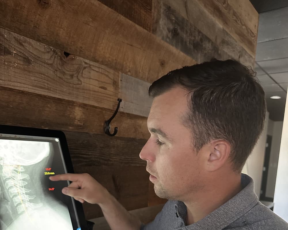 Doctor and patient reviewing spinal x-rays in a one-on-one consultation