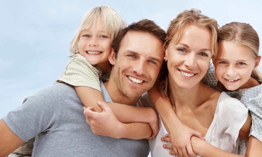 Happy family with young children outdoors